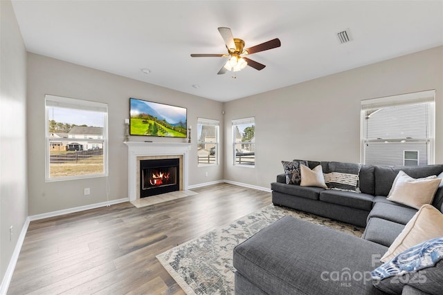 living room featuring hardwood / wood-style flooring and ceiling fan