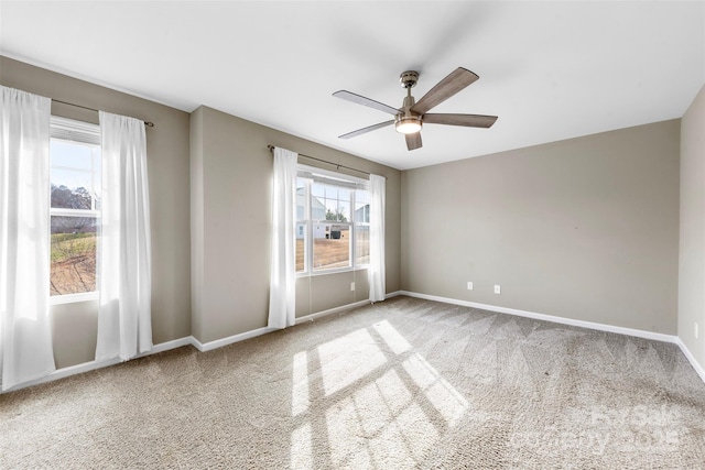 carpeted spare room with ceiling fan