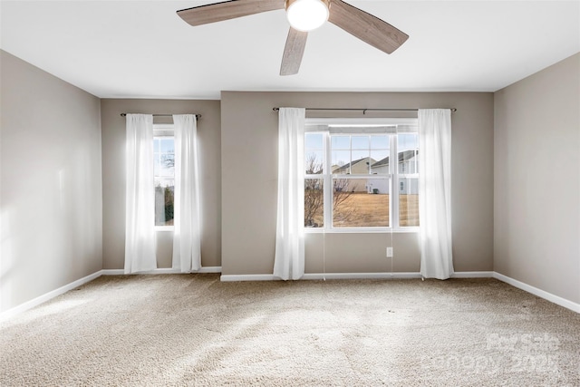 spare room with ceiling fan, a healthy amount of sunlight, and carpet floors