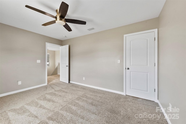 unfurnished bedroom with ceiling fan and light colored carpet