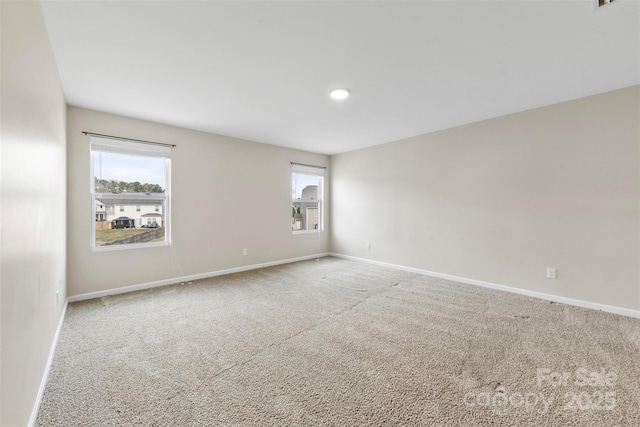 spare room with carpet floors and a healthy amount of sunlight