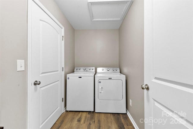 clothes washing area featuring hardwood / wood-style floors and independent washer and dryer