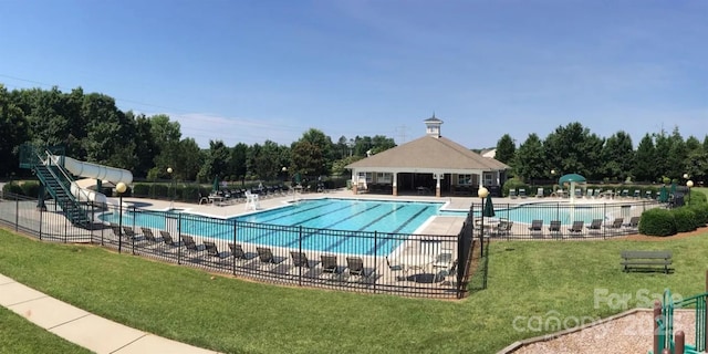 view of pool with a yard, a patio, and a water slide