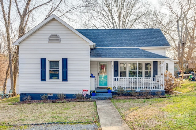 view of front of house with a front yard and covered porch