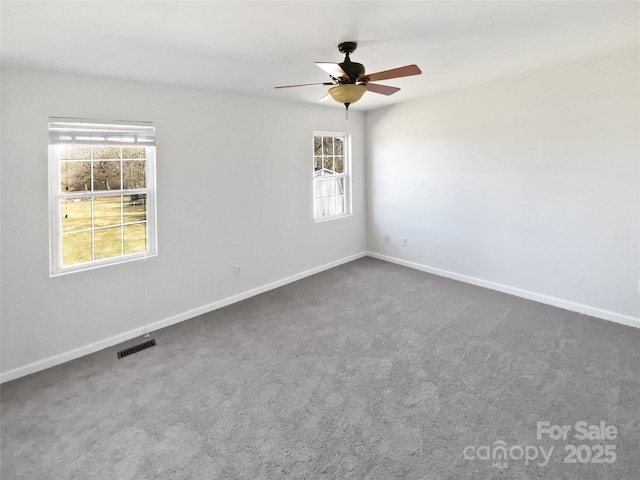 unfurnished room featuring ceiling fan and carpet