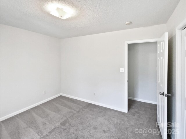 unfurnished room featuring carpet floors and a textured ceiling