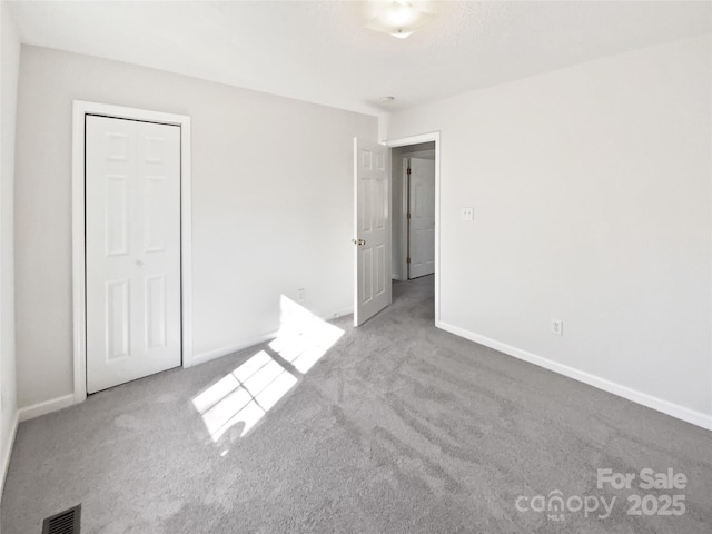 unfurnished bedroom featuring light carpet