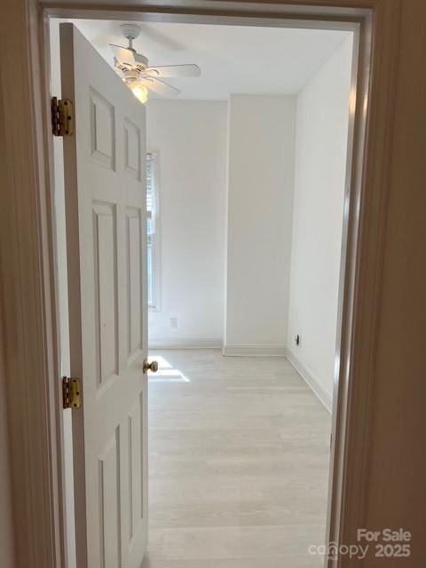 hallway with light hardwood / wood-style flooring