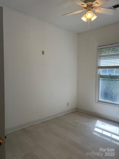 empty room featuring ceiling fan and light hardwood / wood-style flooring