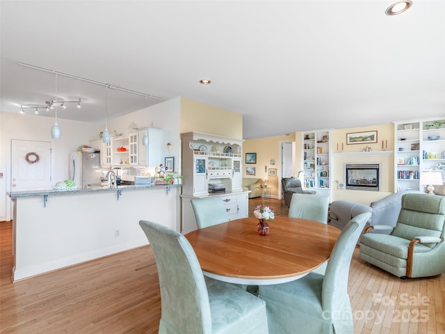 dining room featuring sink and light hardwood / wood-style floors