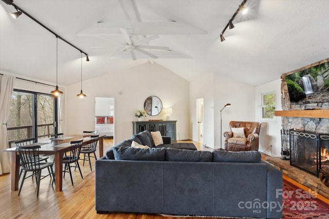 423 Grouse Thicket Rd Unit 238, Mars Hill, NC 28754 - living area featuring track lighting, vaulted ceiling, light wood-style flooring, a fireplace, and ceiling fan