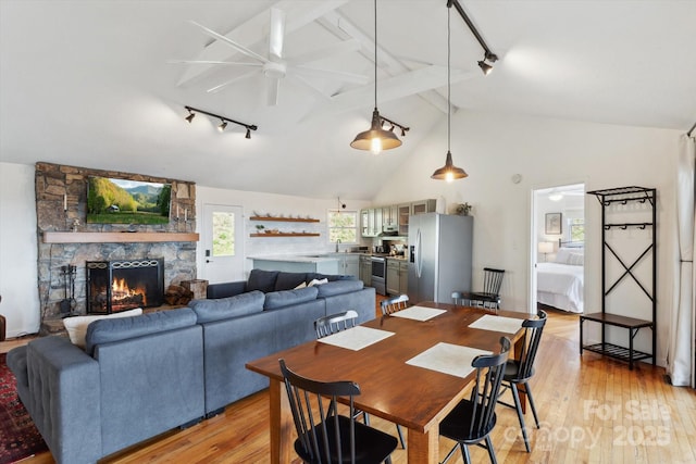 423 Grouse Thicket Rd Unit 238, Mars Hill, NC 28754 - dining area with rail lighting, light wood-style floors, a stone fireplace, and a ceiling fan