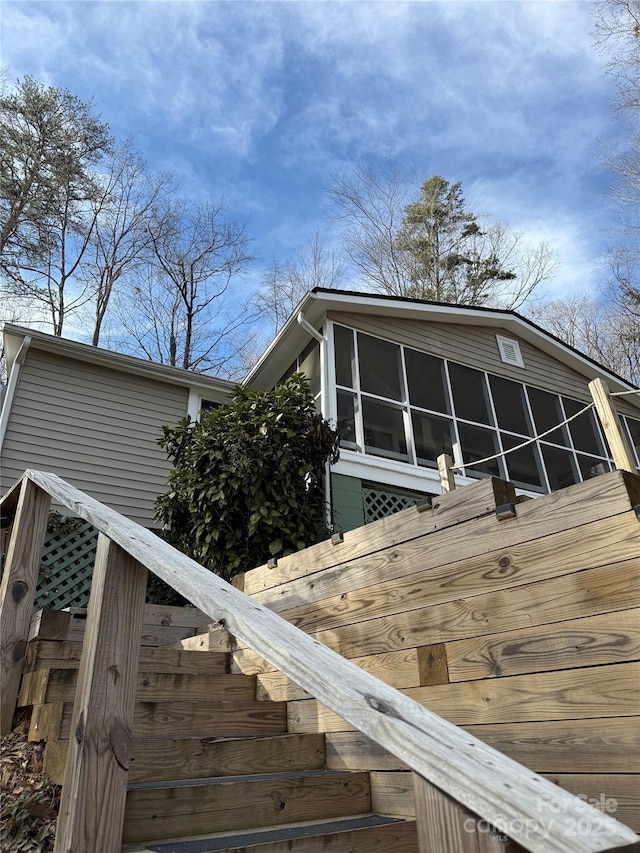 view of side of home featuring a sunroom