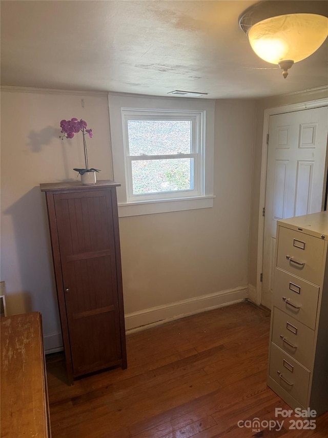 bedroom with baseboards and wood finished floors