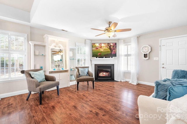 living room with ceiling fan and dark hardwood / wood-style flooring