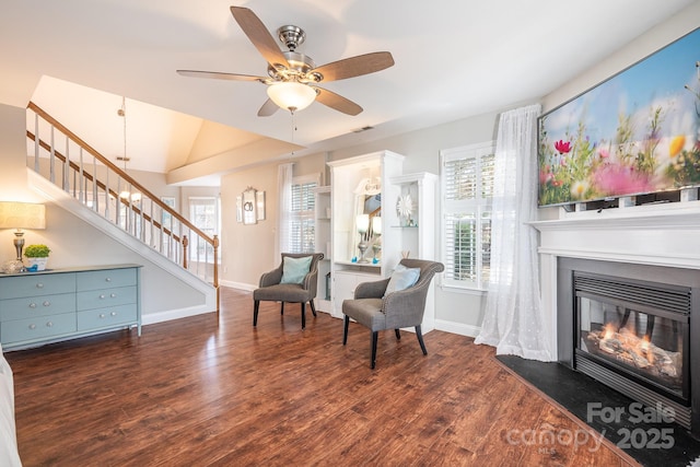 sitting room featuring vaulted ceiling, dark wood-type flooring, and ceiling fan