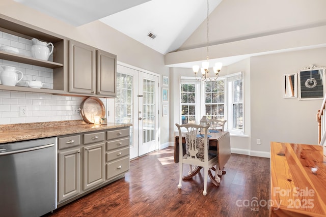 kitchen with a wealth of natural light, decorative light fixtures, stainless steel dishwasher, and french doors