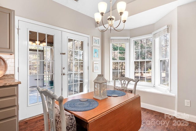 dining room featuring an inviting chandelier, dark hardwood / wood-style flooring, and french doors