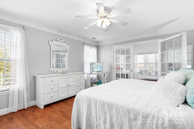 bedroom with multiple windows, ornamental molding, ceiling fan, and light wood-type flooring