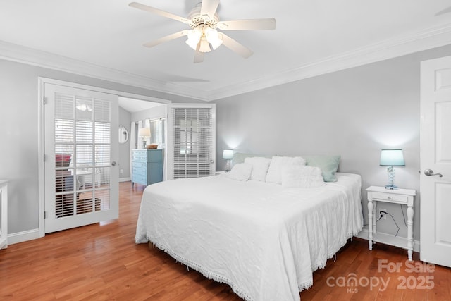 bedroom with hardwood / wood-style flooring, ceiling fan, and ornamental molding