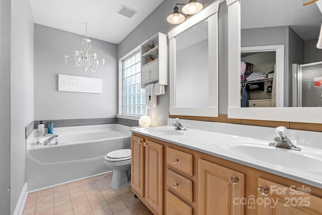 full bathroom featuring vanity, a notable chandelier, plus walk in shower, tile patterned floors, and toilet