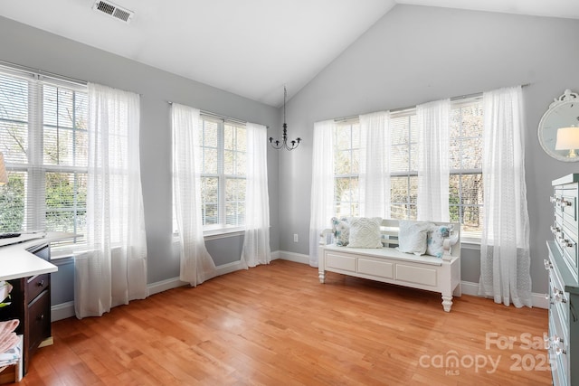 sitting room featuring vaulted ceiling, a notable chandelier, and light hardwood / wood-style floors