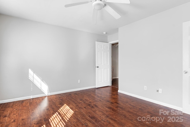 empty room featuring ceiling fan and dark hardwood / wood-style floors