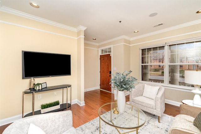 living room with wood-type flooring and crown molding