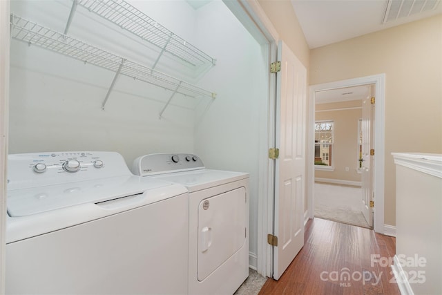 laundry room featuring wood-type flooring and washing machine and dryer