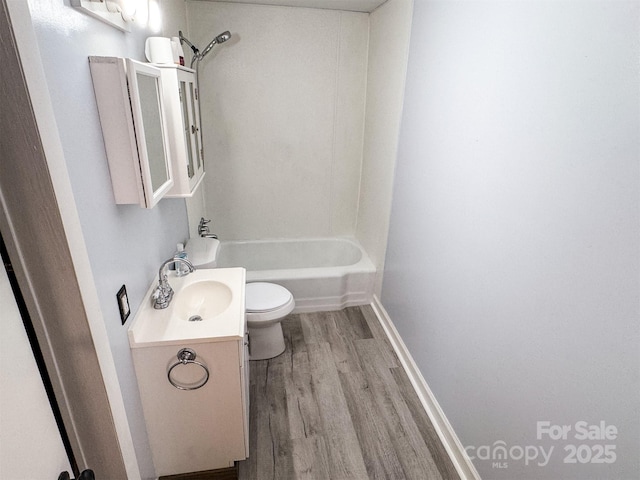 full bathroom with vanity, wood-type flooring, bathing tub / shower combination, and toilet