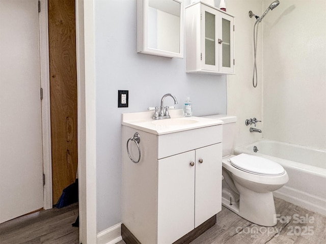 full bathroom featuring hardwood / wood-style flooring, vanity, shower / bathtub combination, and toilet