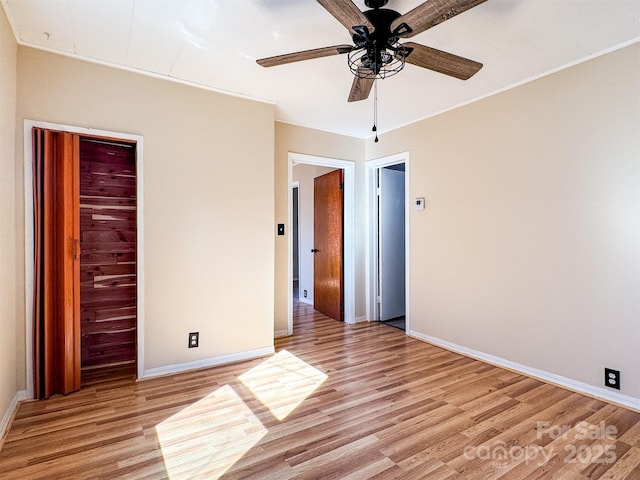 unfurnished bedroom with ornamental molding, ceiling fan, and light hardwood / wood-style floors