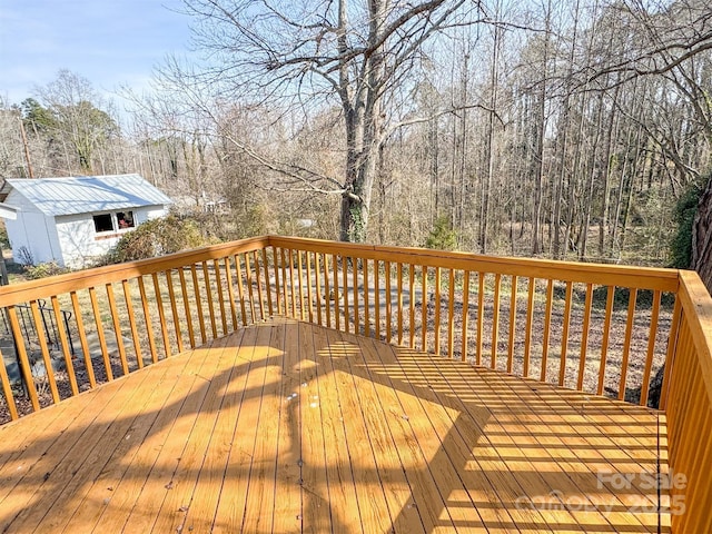 wooden deck featuring a shed