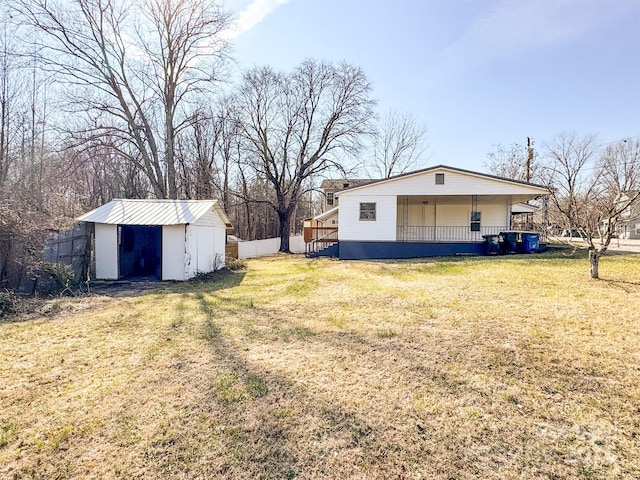 view of yard featuring covered porch and a storage unit