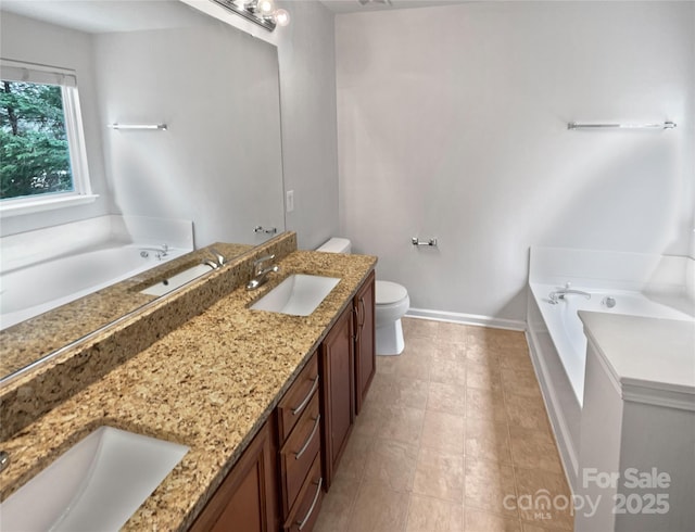 bathroom with vanity, a bath, and toilet