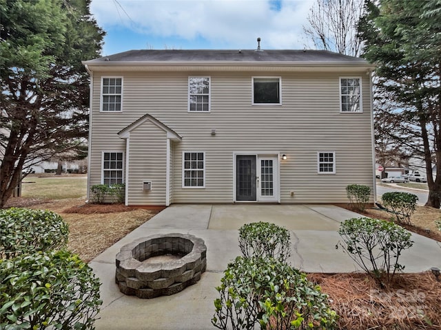 rear view of property with an outdoor fire pit and a patio