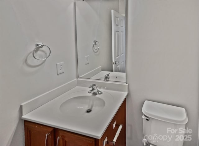 bathroom featuring vanity and toilet