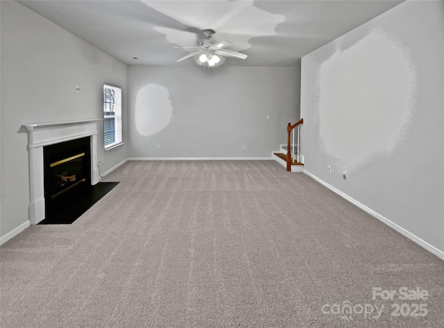 unfurnished living room featuring ceiling fan and light carpet