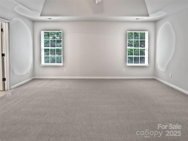 unfurnished room featuring light carpet and lofted ceiling