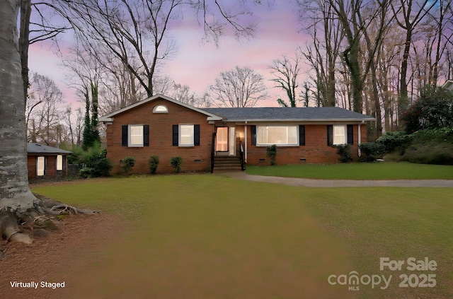 single story home featuring a yard