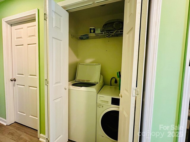 washroom featuring washer and clothes dryer and light wood-type flooring