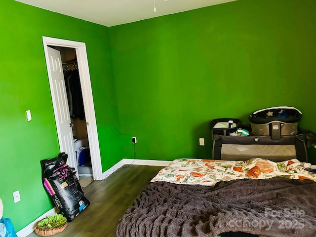 bedroom with dark hardwood / wood-style flooring