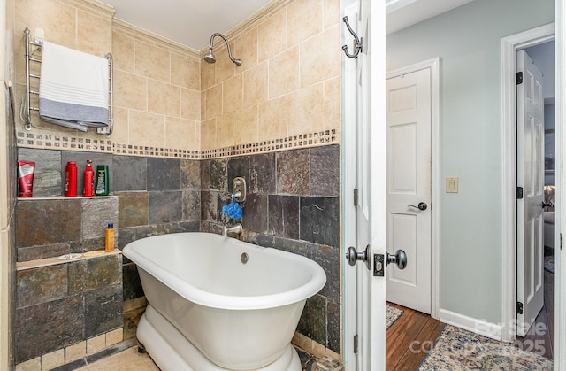 full bath with a soaking tub, tile walls, radiator heating unit, and wood finished floors