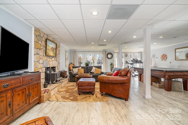 living area with crown molding, decorative columns, light wood finished floors, recessed lighting, and visible vents