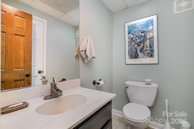 half bathroom with a paneled ceiling, visible vents, toilet, and vanity