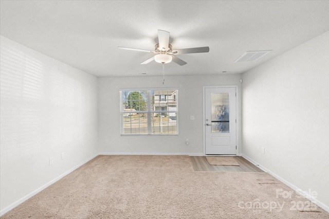 carpeted empty room featuring ceiling fan