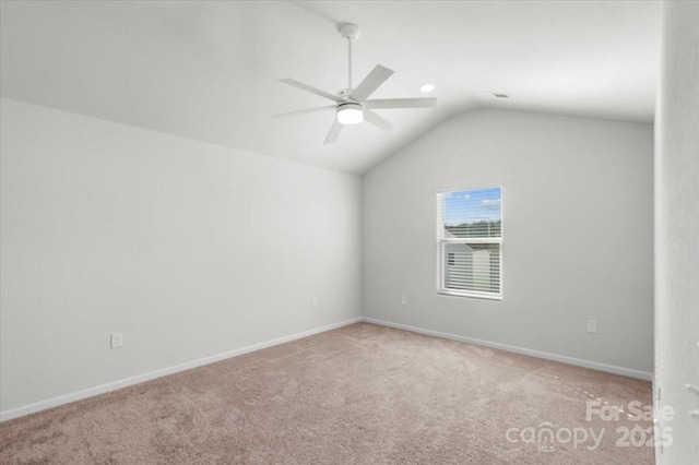 unfurnished room featuring ceiling fan, lofted ceiling, and carpet floors