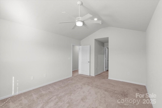 interior space featuring lofted ceiling, light carpet, and ceiling fan