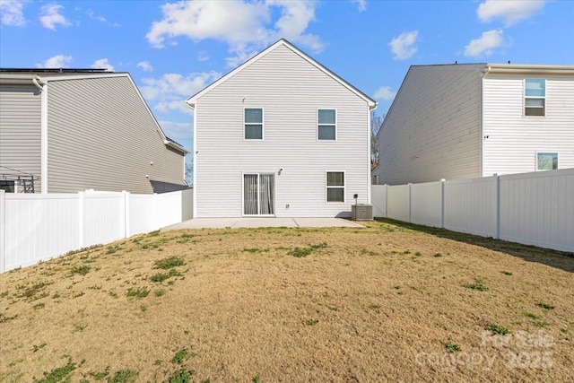 rear view of house with a yard, central AC unit, and a patio area