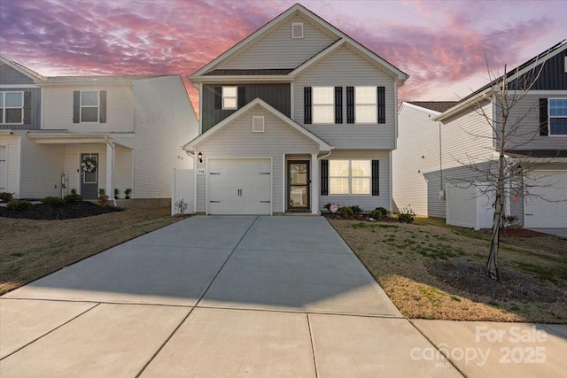 front facade with a garage and a lawn